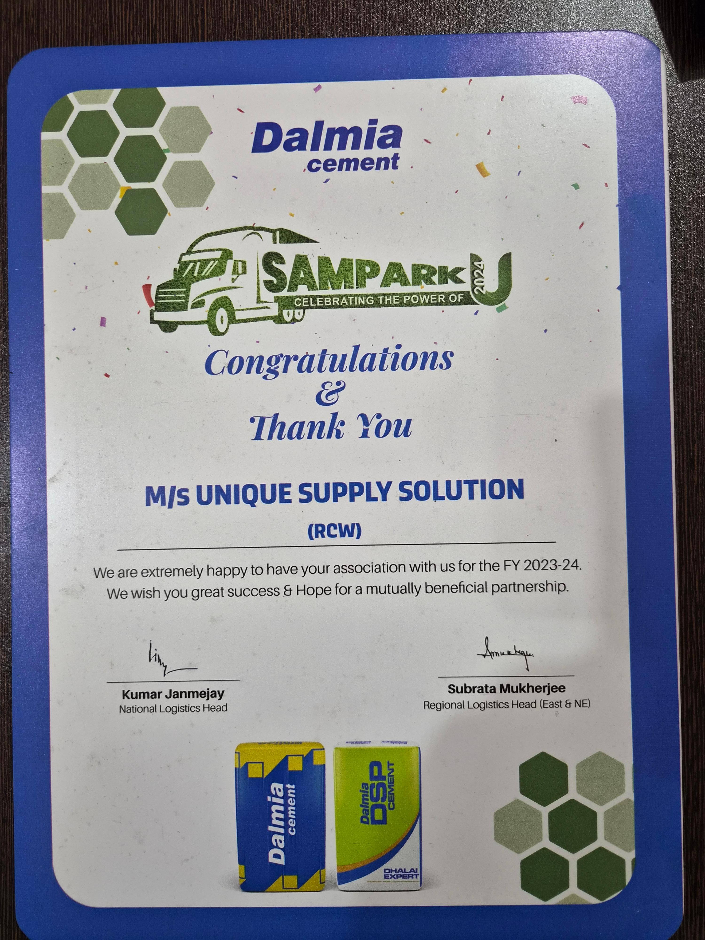 An appreciation certificate from Dalmia Cement's SAMPARK U 2024 programme, addressed to M/s Unique Supply Solution (RCW), thanking the company for its association during the 2023-24 financial year