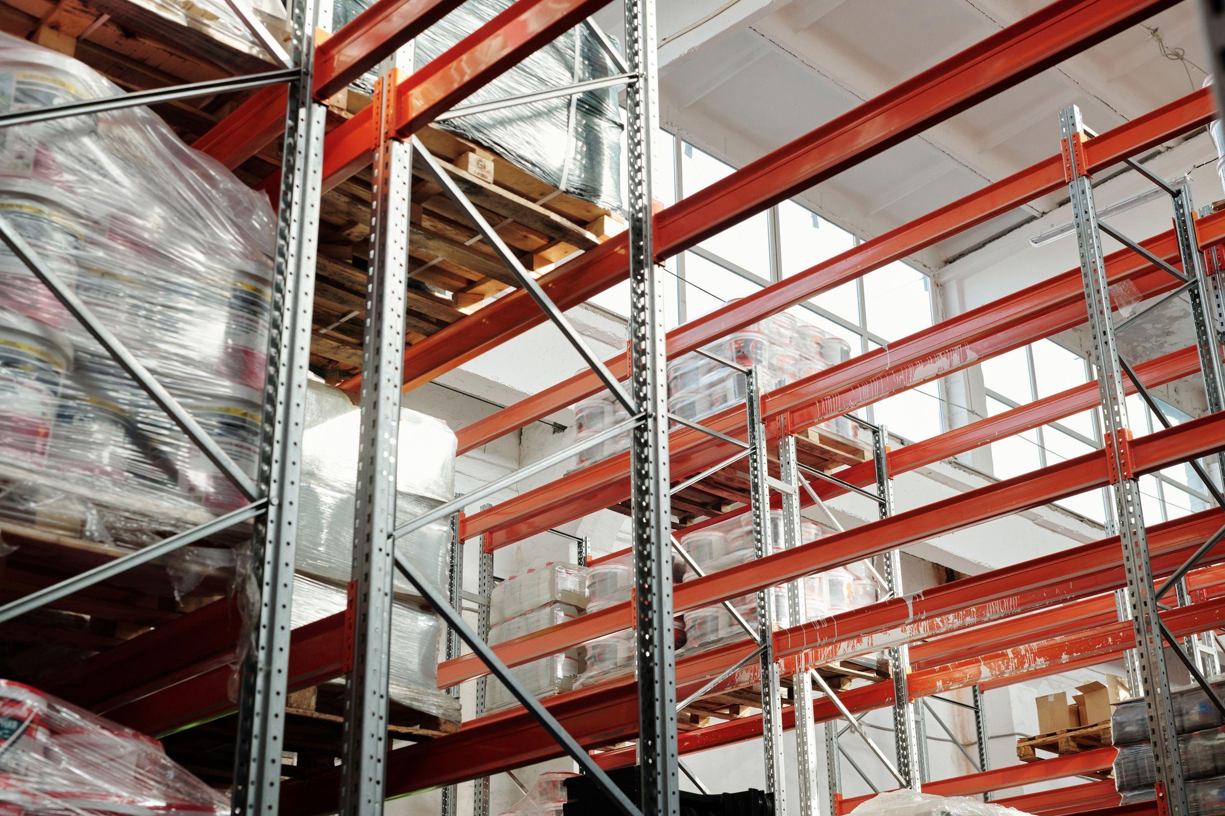 Pallet racking stacked with wrapped goods inside a distribution warehouse